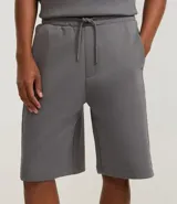 Bermuda masculina de algodón y poliéster, color gris oscuro, con cintura elástica y cordón ajustable. Presenta bolsillos funcionales.