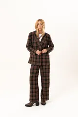 Pantalon de vestir de corte recto y tiro alto, confeccionado en tela con estampado de cuadros en tonos marrones y negros.