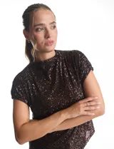 Blusa de cuello redondo y manga corta, completamente cubierta de lentejuelas en color marrón oscuro. Presenta un diseño de corte recto y forro interno a tono.