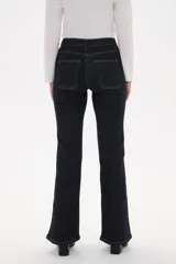 Pantalon de jean azul oscuro con corte flare, tiro alto y bolsillos frontales tipo parche.