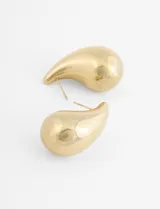 Aros de acero quirúrgico en diseño de gota tridimensional de gran tamaño y acabado dorado brillante.