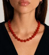 Collar de cuentas esféricas de color rojo intenso, ensartadas con nudos entre cada una para mayor flexibilidad y seguridad.