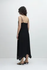 Maxi vestido negro de breteles finos con escote en V y detalle de encaje en el busto.