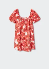Vestido corto de algodón con estampado de margaritas rojas sobre fondo blanco. Presenta un diseño evasé, escote cuadrado con cierre de lazo ajustable, mangas cortas abullonadas y forro interior.