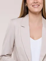 Blazer de sastre entallado color gris claro, con solapa de muesca clásica, cierre frontal de un solo botón y bolsillos frontales de vivo horizontales.