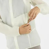 Campera cortavientos de mujer Salomon Sense Aero Wind, ultraligera y transpirable, color blanco semitransparente, con capucha y cierre frontal completo.