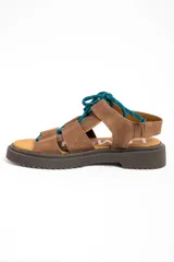Sandalias de cuero color marrón, con suela track marrón oscura y cordones estilo marinero en color verde azulado que cruzan la capellada.