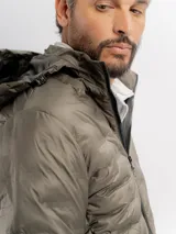 Campera puffer negra con diseño capitoneado, cierre frontal completo y capucha integrada.