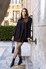 Vestido corto negro sin mangas, de corte recto y falda evasé.