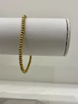 Pulsera elástica con bolitas de acero quirúrgico de 3mm de diámetro.