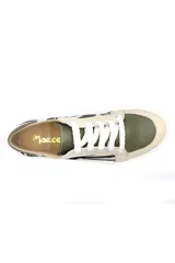 Zapatillas deportivas bajas de cuero con estampado de cebra en blanco y negro, detalles en verde oliva y cordones blancos.