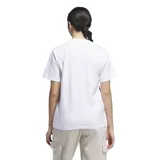 Remera de algodón blanca con cuello redondo y mangas cortas. Presenta un estampado frontal con el logo de Adidas sobre un diseño de flor en tonos lila y rosado.