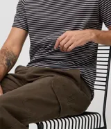 Pantalón cargo de corte recto en color beige, confeccionado en tejido de sarga de algodón. Cuenta con bolsillos laterales y bolsillos cargo con solapa en las piernas, cintura con pasacintos y cierre frontal con botón y cremallera.