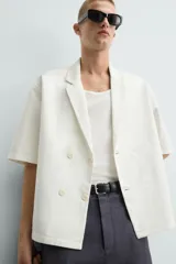 Camisa blanca de manga corta con cuello de solapa de muesca y cierre cruzado de doble botonadura.