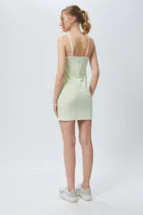 Vestido corto al cuerpo a cuadrillé blanco y negro, con cuello alto y mangas cortas.