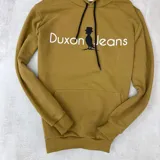 Canguro mostaza de algodón sin felpa, con capucha y cordones negros. Estampa frontal con el logo de la marca Duxon Jeans en blanco y negro.