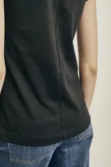 Remera negra de algodón peinado con escote en V y detalle de calado en el borde.