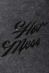 Remera de morley con efecto lavado y mangas raglán, de color negro, corte ajustado al cuerpo y aplique frontal con la inscripción "Hot Mess".
