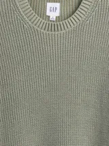 Buzo de tejido de punto acanalado con cuello redondo, mangas largas y puños ajustados.