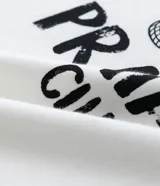 Remera blanca de algodón con estampa de una figura femenina con un blazer a rayas y un bolso de mimbre.