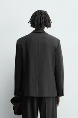 Blazer de corte regular confeccionado en tejido con lana, con cuello de solapas de muesca, cierre frontal de un botón, bolsillos con solapa en la cadera y bolsillo de vivo en el pecho.