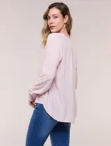 Blusa celeste fluida de viscosa, con escote en V y cuello mao, mangas largas y pliegue central en el delantero.