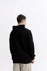 Canguro con capucha y cordones ajustables, de corte holgado y bolsillo frontal tipo canguro. Presenta un pequeño logo estampado en el pecho.