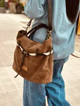 Bolso marrón de cuero gamuzado con correa bandolera de cuero marrón y detalle de cuero con estampado animal print.