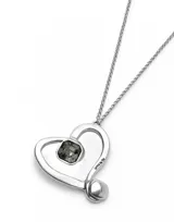 Colgante largo con cadena plateada y dije en forma de corazón con cristal facetado negro.