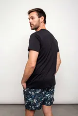 Short de baño con estampado de hojas de palmera en tonos azul, verde y blanco.