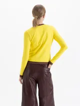 Remera de algodón pima con elastano, color rojo, de calce ajustado al cuerpo, manga larga y cuello redondo con detalles en color azul. Presenta estampa frontal con la palabra 'CUPIDO' y diseño de labios.