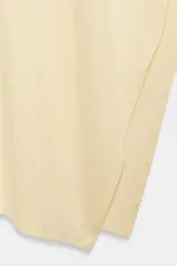 Top asimétrico de mezcla de lyocell en color amarillo claro, con cuello redondo y diseño fluido de corte irregular con una manga larga y un lateral drapeado.