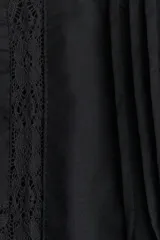 Pollera corta acampanada negra de algodón, con detalles de pinzas y paneles de encaje en el frente y laterales. Presenta un ruedo con terminación de encaje festoneado.