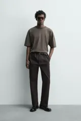 Pantalón chino regular fit de color negro, confeccionado en tejido de algodón. Cuenta con bolsillos frontales, detalle de bolsillo cerillero, bolsillos traseros de doble vivo y cierre frontal con cremallera y botón.