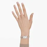 Reloj Swarovski Dextera Chain con caja octogonal de 44 mm con acabado en tono oro champán y bisel con pavé de cristales. Esfera blanca iridiscente con logo de cisne a las 12. Pulsera de cadena gourmette ajustable adornada con cristales.