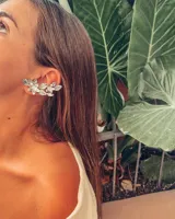 Aro trepador plateado con forma de hojas y flores con incrustaciones de piedras transparentes.