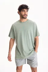 Remera oversize de manga corta y cuello redondo, confeccionada en algodón con acabado lavado estilo vintage.