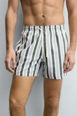 Bañador de hombre de tejido técnico con estampado de rayas verticales en verde oscuro, azul claro y blanco. Presenta cintura elástica ajustable con cordón blanco, bolsillos laterales y un bolsillo trasero de vivo.