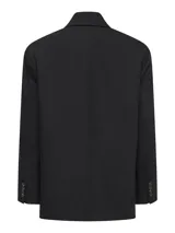 Blazer oversize color negro, con solapa clásica, bolsillos con ribete y diseño amplio de manga larga.