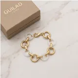 Pulsera de eslabones alternados, combinando eslabones circulares de metal dorado con eslabones circulares de cerámica blanca.