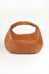 Bolso negro tipo hobo de cuero sintético, con asa corta fija y cierre superior.
