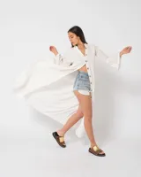 Camisola larga color verde esmeralda con botones de madera, corte holgado, cuello mao y mangas largas acampanadas con volados.