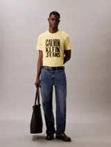 Remera amarilla de algodón con cuello redondo y estampado del logo de Calvin Klein Jeans en negro.