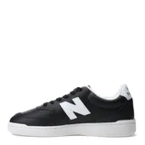 Championes urbanos New Balance modelo 080, color negro con detalles en blanco. Presentan una silueta clásica de corte bajo, con el logo 'N' en el lateral y suela de goma blanca.