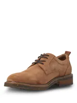 Zapato de vestir tipo derby marca Hush Puppies, confeccionado en cuero gamuzado color tostado. Presenta cordones oscuros, costuras reforzadas y suela de goma con efecto moteado.