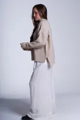 Sweater tejido de punto color beige, con cuello alto y trama lineal.