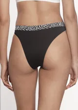 Pack de tres bombachas vedetinas de microfibra sin costuras. El set incluye una unidad negra, una blanca y una gris claro, todas con una banda elástica superior con estampado animal print tipo cebra.