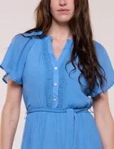 Vestido midi color azul, de silueta fluida estilo bohemio, con escote en V, pechera con detalle de encaje, mangas cortas con vuelo, cintura elástica con lazo ajustable y falda escalonada con volados.