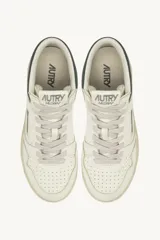 Championes de cuero blanco con detalles en verde oscuro en el talón y la suela. Presentan el logo de Autry con la bandera de Estados Unidos en el lateral.