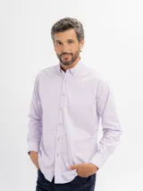 Camisa de manga larga marca Cuatro Ases, confeccionada en algodón con diseño de microcuadros en tono azul claro. Presenta cuello clásico con botones, cierre frontal abotonado y bolsillo en el pecho.